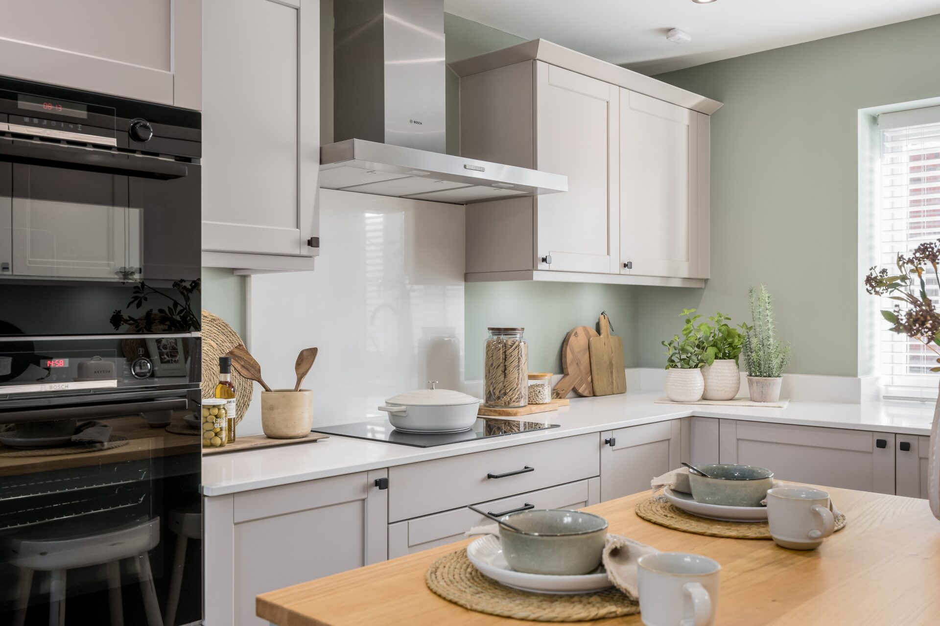 A view of the kitchen with induction hob and double oven inside the Morden home by Wyatt Homes.