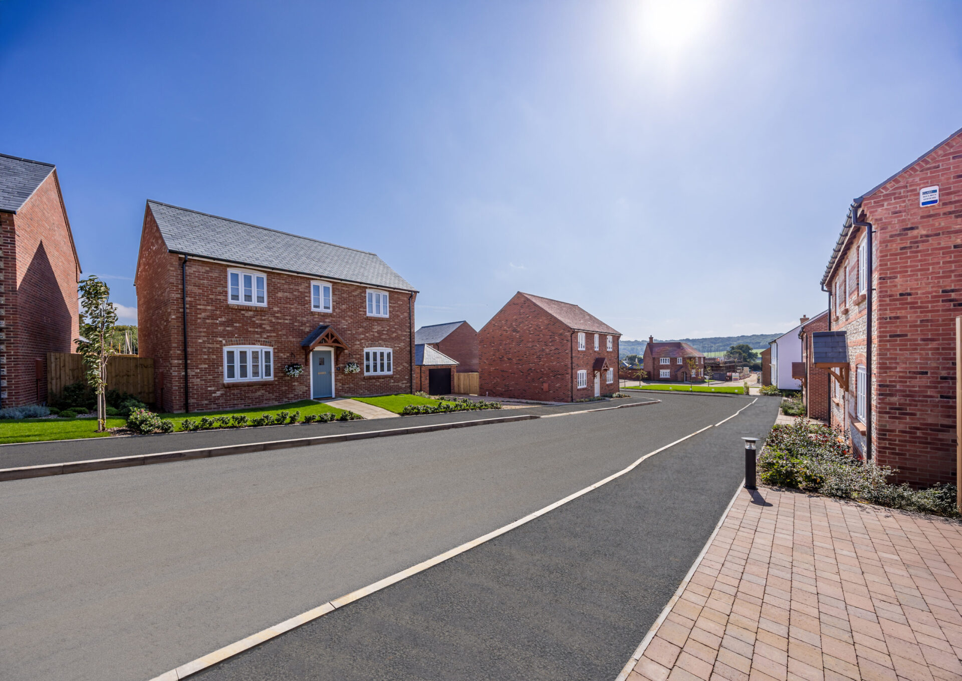 A street scene of new homes in Sturminster Newton, at Fiddleford Ridge by Wyatt Homes.